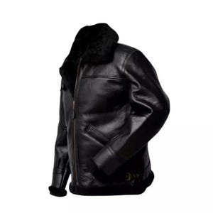 May include: A black leather jacket with a shearling collar and lining. The jacket features a front zipper closure, a small pocket, and a buckled belt detail at the waist. The sleeves have a fur trim at the cuffs.
