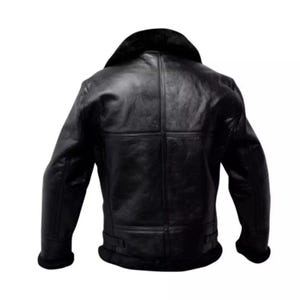 May include: A black leather jacket with a shearling collar and lining. The jacket has a classic design with a wide collar, a front zipper, and a belted waist. The jacket is made of a thick, durable leather and is designed to provide warmth and protection.