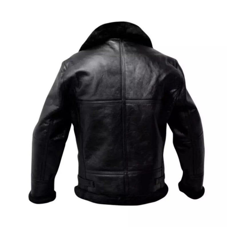 May include: A black leather jacket with a shearling collar and lining. The jacket has a classic design with a wide collar, a front zipper, and a belted waist. The jacket is made of a thick, durable leather and is designed to provide warmth and protection.