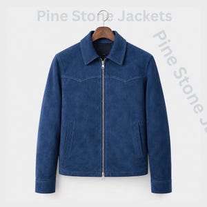 May include: A blue suede jacket with a pointed collar, a full-length silver metal zipper, and two vertical side pockets. The jacket features western-style shoulder yokes and buttoned cuffs. The text Pine Stone Jackets is visible in the background.