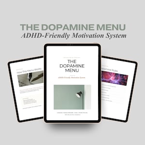 May include: Three tablets displaying the text "THE DOPAMINE MENU ADHD-Friendly Motivation System." The central tablet shows a lamp and the text "CHOOSE YOUR REWARD. FUEL YOUR FOCUS." The other tablets show text and images.
