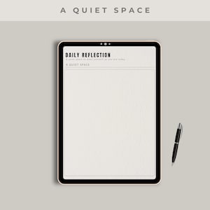 May include: A digital tablet with a black border displays a "Daily Reflection" page. The text "A QUIET SPACE" is at the top and bottom of the page. A black pen rests beside the tablet on a light gray surface.