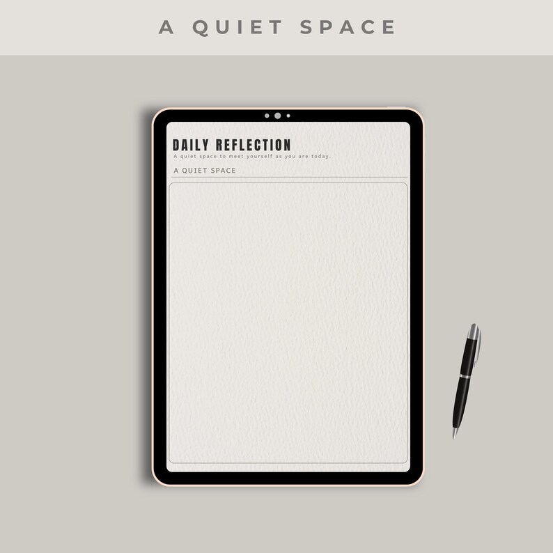 May include: A digital tablet with a black border displays a "Daily Reflection" page. The text "A QUIET SPACE" is at the top and bottom of the page. A black pen rests beside the tablet on a light gray surface.
