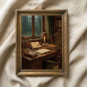 May include: A framed print of a vintage study scene. The image features a wooden desk with open books, a lit candle, and a quill pen. Bookshelves and a window with a view of a forest are in the background. The frame is a warm, golden brown.