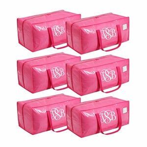 May include: Six bright pink storage bags with white monogrammed initials. Each bag has a rectangular shape, a zipper closure, and two handles. The bags are arranged in two rows of three.