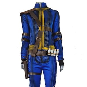 May include: Blue and yellow jumpsuit with brown leather accents, knee pads, and boot covers. The costume includes a brown shoulder strap, belt, and a holster. The outfit has a high collar and is designed with multiple straps and buckles.