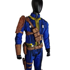 May include: A blue jumpsuit with yellow accents, brown leather shoulder armor, and utility pouches. The costume includes a brown belt, leg holsters, and black gloves. The outfit is displayed on a mannequin.