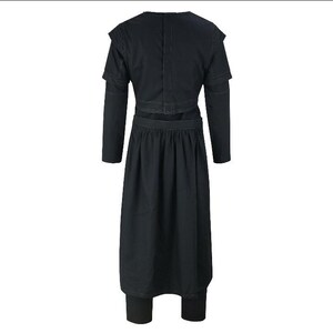May include: A black, long-sleeved dress with a layered bodice and a gathered skirt. The dress features a high neckline and fitted leggings. The back of the dress is visible, showcasing the stitching details and design.