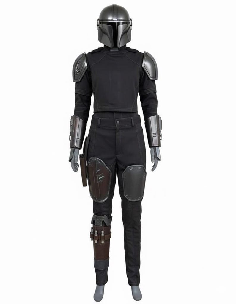 May include: A full Mandalorian costume. It features a silver helmet, shoulder armour, and gauntlets. The outfit includes a black shirt and trousers, with knee and thigh armour. A holster and leg wraps complete the ensemble. The costume is designed for cosplay.