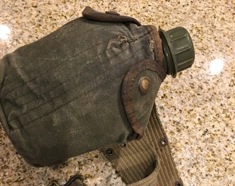 Old army canteen and belt rustic military green