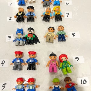 May include: A collection of 10 sets of Lego minifigures, each set containing two minifigures. The minifigures are from various themes, including Toy Story, Batman, and Disney.