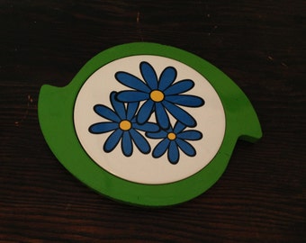 Mod Flower  shaped metal trivet with blue funky floral design ceramic tile center