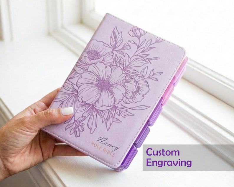 Custom engraved KJV Bible for women showcasing a soft purple leather binding, personalized name on the front cover, coordinating pink tabs, and traditional King James Version scripture, making a beautiful Christian keepsake gift for her faith journey