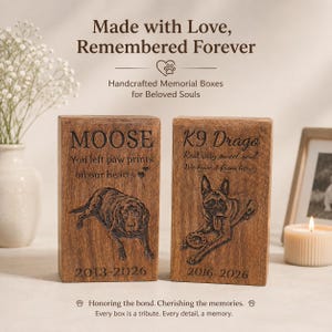 Puede incluir: Dos cajas conmemorativas rectangulares de madera con retratos de perros grabados y texto. La caja izquierda dice MOOSE, You left paw prints on our hearts, 2013-2026. La caja derecha dice K9 Drago, Rest easy sweet soul, We have it from here, 2016-2026.