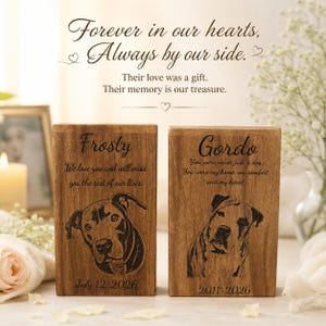 Puede incluir: Dos placas conmemorativas rectangulares de madera con retratos de perros grabados. La placa izquierda dice Frosty, We love you and will miss you the rest of our lives, July 12, 2026. La placa derecha dice Gordo, You were never just a dog, You were my home, my comfort, and my heart, 2011-2026.