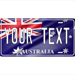 May include: A rectangular license plate design featuring the Australian flag in the upper left corner. The plate has a dark blue background with the words "YOUR TEXT" in white block letters. The word "AUSTRALIA" is at the bottom.