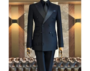 May include: A black double-breasted suit with a satin lapel, black shirt, and tie. The suit is displayed on a mannequin. The brand name "VELLARO" is visible in the image.