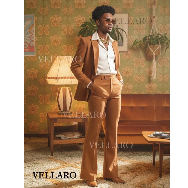 May include: A brown suit featuring a blazer and flared trousers. The suit is paired with a white shirt and gold chain. The image has a retro style, taken indoors.