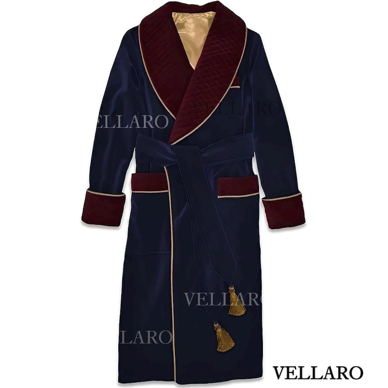 May include: A navy blue velvet dressing gown with a quilted burgundy collar and cuffs. Gold trim edges the gown, pockets, and belt. The robe has a matching belt and tassels. The brand name "VELLARO" is visible.