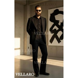 May include: A black suit, including a blazer and trousers, is worn by a person in a well-lit room. The suit is paired with a black shirt and sunglasses. The word "VELLARO" is printed on the image.