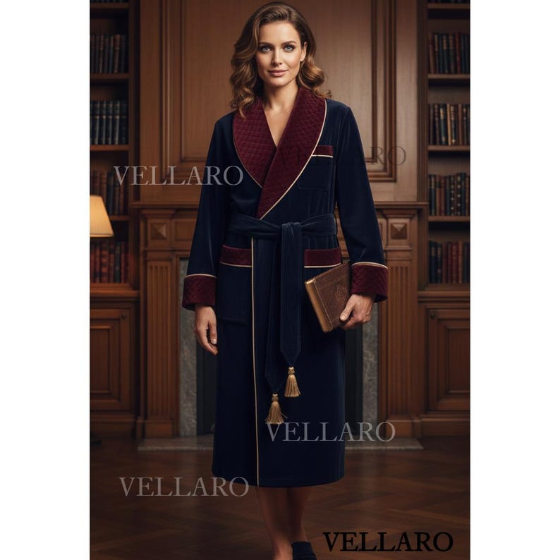 May include: A navy blue velvet dressing gown with a burgundy shawl collar and cuffs, trimmed with gold. It has a matching belt and tassel details. The brand name "VELLARO" is visible on the gown.
