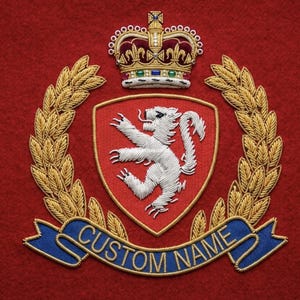 May include: Embroidered crest on a red background. The crest features a white lion on a red shield, a gold crown, and a banner with "CUSTOM NAME" in gold lettering. Gold wheat stalks and a blue banner complete the design.