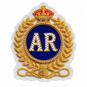 May include: A white felt patch featuring a central blue circle with the letters AR embroidered in white beads. The design is surrounded by gold bullion wire laurel leaves and topped with a gold crown accented with red fabric and small colourful beads.