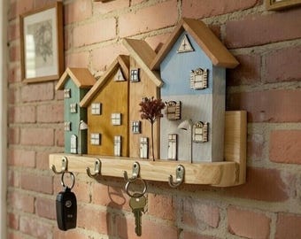 A Wooden Key Holder Decorated With Colorful Little Houses