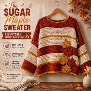 May include: A crochet jumper featuring horizontal stripes in rust orange, cream, and yellow. The jumper is adorned with several three-dimensional crochet maple leaves in shades of orange and yellow on the front. Text reads The Sugar Maple Sweater.