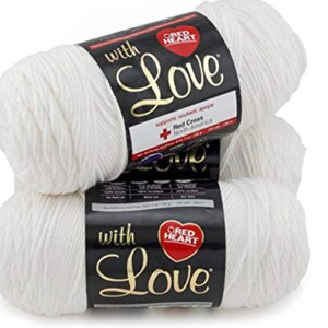 May include: Three white skeins of Red Heart With Love yarn. The yarn is soft and fluffy, and the label features the Red Heart logo and the words "With Love".