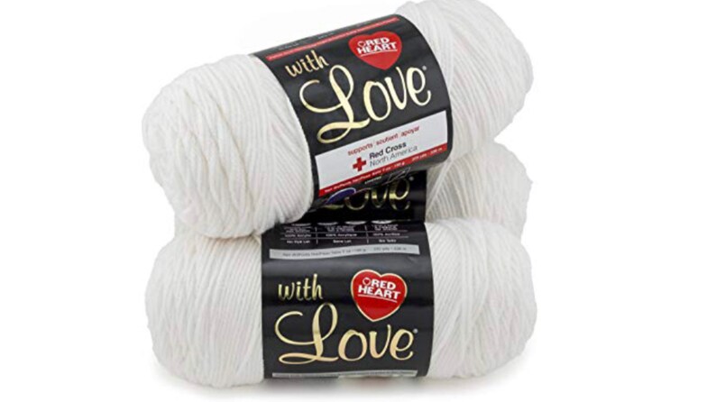 May include: Three white skeins of Red Heart With Love yarn. The yarn is soft and fluffy, and the label features the Red Heart logo and the words "With Love".