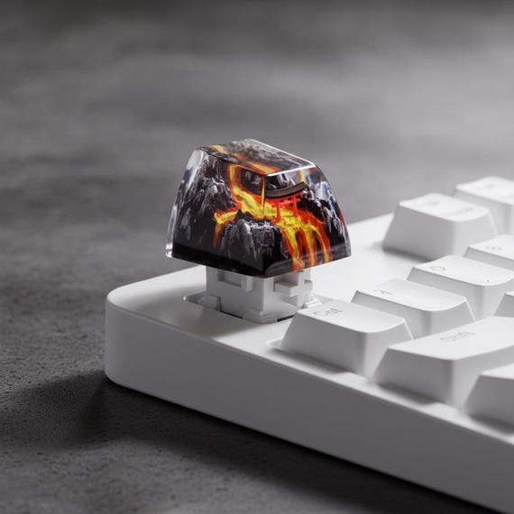 A hand-sculpted resin keycap featuring a miniature Torii gate volcano landscape — tiny wearable diorama art for your mechanical keyboard.