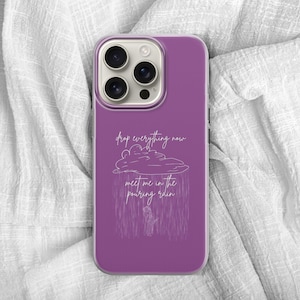 May include: A purple phone case with a white illustration of a cloud and rain, with the text "drop everything now meet me in the pouring rain". The phone case has a camera bump.