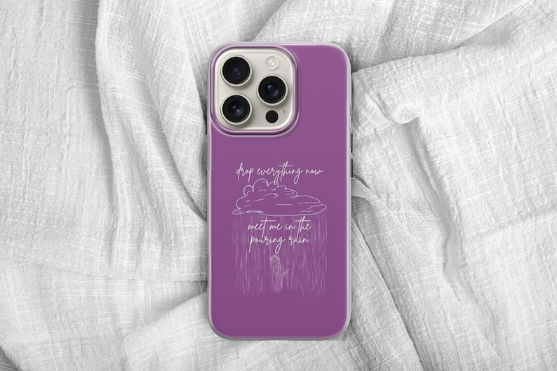 May include: A purple phone case with a white illustration of a cloud and rain, with the text "drop everything now meet me in the pouring rain". The phone case has a camera bump.