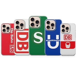 Può includere: Una collezione di custodie per telefoni in vari colori, ognuna con un design diverso. Le custodie mostrano loghi e testo, tra cui "DB", "S" e "Stadtbahn". Le custodie sono rosse, bianche, verdi, blu e bianche.