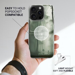 May include: Clear phone case with a forest scene design. The case features a misty forest with a figure walking on a path. Text on the case reads "Everything you lose is a step you take." The case is described as easy to hold, Popsocket compatible, light weight, soft and flexible.