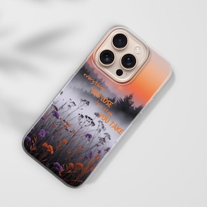 May include: A clear phone case with a landscape design featuring a misty forest, wildflowers, and an orange and pink sunset. The case has the quote "everything you lose is a step you take".