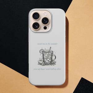 May include: A light gray phone case featuring a black and white illustration of a glass of iced tea with a lemon slice and straw. The text "sweet tea in the summer" and "cross my heart won't tell no other" are above and below the image.