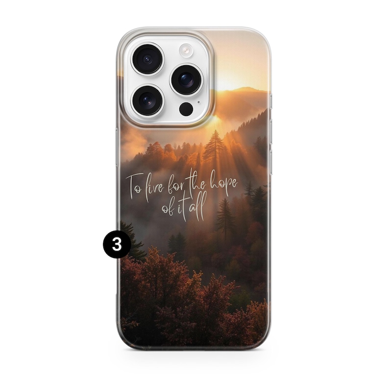 May include: Clear phone case featuring a scenic landscape of a mountain forest at sunset. The image includes a quote in cursive that reads, "To live for the hope of it all." The case is designed to fit a smartphone.