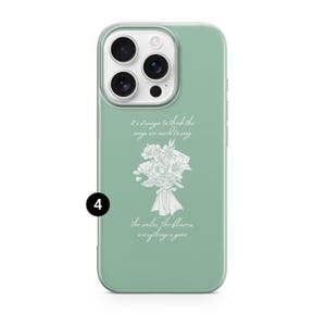 May include: A mint green phone case with a white floral bouquet design and the text "it's strange to think the songs we used to sing, the smiles the flowers everything is gone". The case has a clear border.