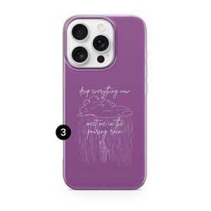 May include: A purple phone case with a white graphic of a cloud, rain, and a person. The text on the case reads "drop everything now meet me in the pouring rain."