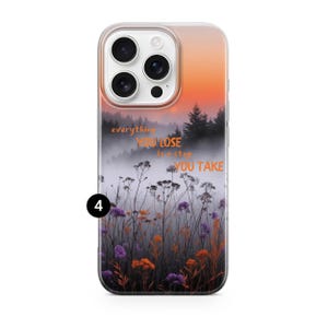May include: A smartphone case featuring a scenic landscape with a misty forest and colorful wildflowers. The case has an orange and yellow gradient sky and the text "everything you lose is a step you take."