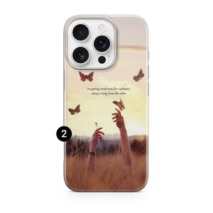 May include: A phone case featuring a sunset scene with butterflies and the text "I'm getting tired even for a phoenix, always rising from the ashes." The case has a clear border and a design of hands reaching up.