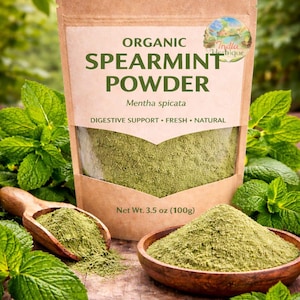 May include: A package of organic spearmint powder with the text "SPEARMINT POWDER" and "Mentha spicata". The package is brown with a clear window, and the powder is green. A wooden scoop and bowl contain the powder, surrounded by fresh mint leaves. Net Wt. 3.5 oz (100g).