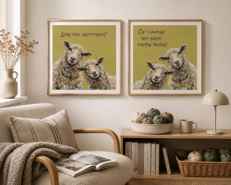 May include: Two square framed wall art prints featuring illustrations of sheep on a mustard yellow background. The left print displays the text "Are you knitting?" and the right print displays the text "Of course you need more yarn!" in black lettering.