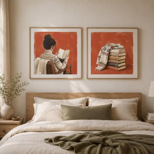 May include: Two square framed wall art prints featuring a burnt orange background. The left print shows a person in a cream-coloured patterned jumper reading a book. The right print displays a stack of books topped with a folded patterned jumper.