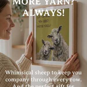 May include: A framed wall art print featuring an olive green background with two sheep and the text "Of course you need more yarn!". The print is housed in a light-colored wooden frame, showcasing a detailed illustration of the sheep.