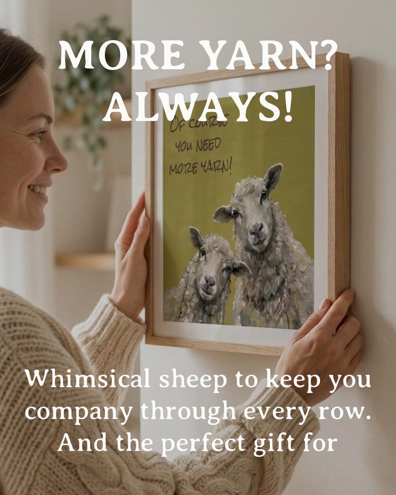 May include: A framed wall art print featuring an olive green background with two sheep and the text "Of course you need more yarn!". The print is housed in a light-colored wooden frame, showcasing a detailed illustration of the sheep.