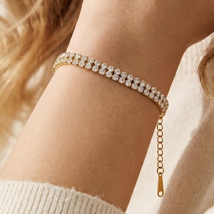 May include: A rustic wooden sign with the text "Welcome to our home" in white lettering. The sign features a distressed finish and a simple, inviting design, perfect for front door decor.