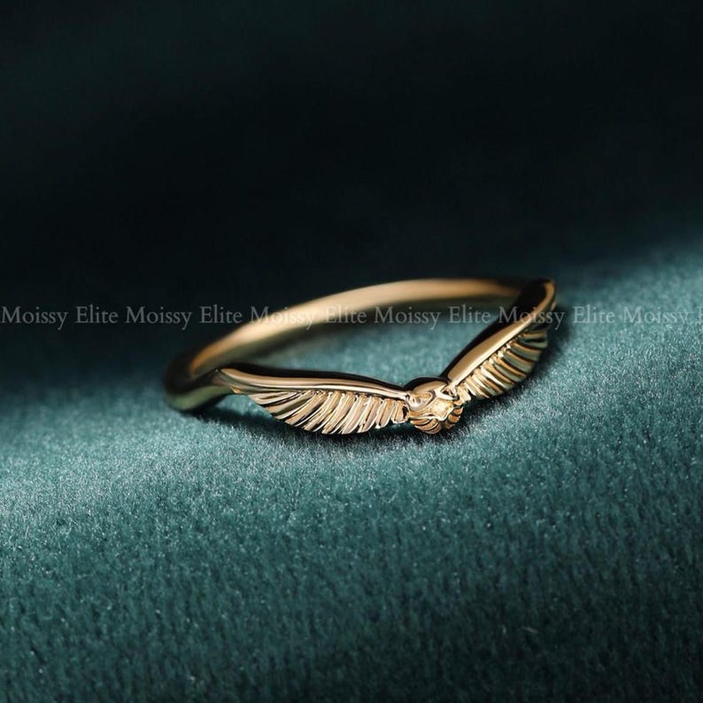 Engraved 14k gold wing band with filigree details, minimalist vintage inspired stacking wedding ring worn on finger.
